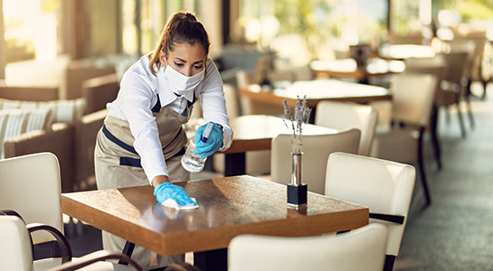 GBAC restaurant working disinfecting table